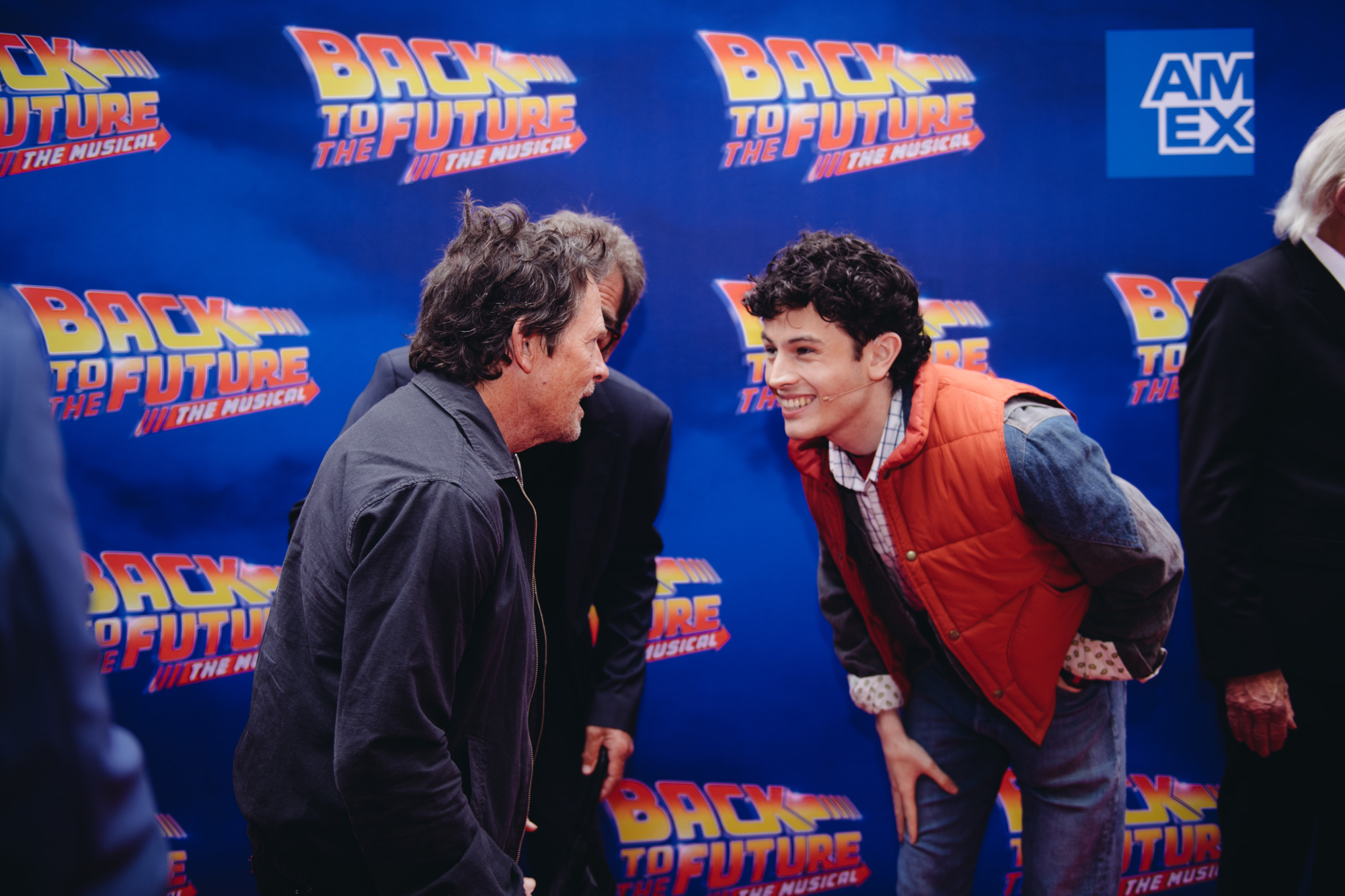 Michael J. Fox and Casey Likes smiling at each other at the Back to the Future Musical Gala